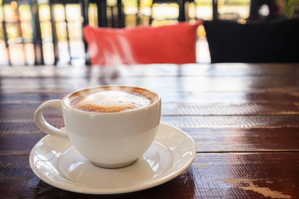 Herzform Latte Art in weißer Kaffeetasse auf Holztisch im Café Restaurant - Foto, Bild