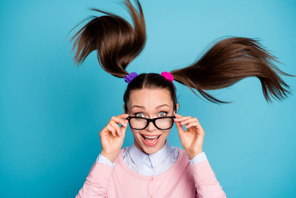 Portrait of crazy funny funky high school girl student touch spectacles impressed incredible lesson lecture schedule wear pastel clothes hair fly isolated blue color background - Fotó, kép