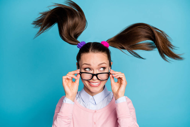 Close-up portrait of her she nice attractive pretty curious glad girlish cheerful college girl peeking creating solution hair flying isolated over bright vivid shine vibrant blue color background - Foto, imagen
