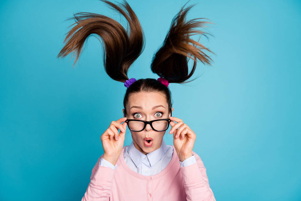 Portrait of astonished girl touch hands spectacles impressed graduation exam news haircut air fly wear pastel sweater isolated over blue color background - Foto, Imagem