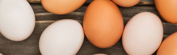 top view of fresh chicken eggs on wooden surface, panoramic shot - Photo, Image