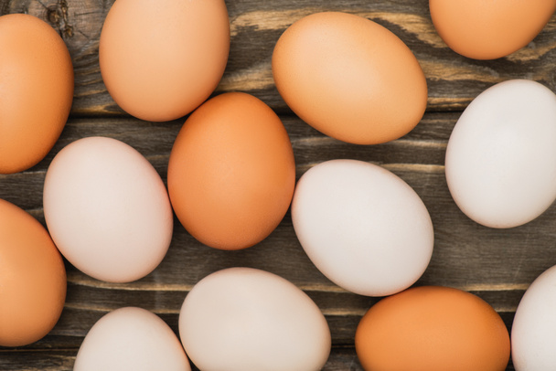 top view of fresh chicken eggs on wooden surface - Fotografie, Obrázek