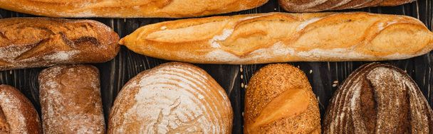 top view of fresh baked bread loaves, panoramic shot - Fotó, kép
