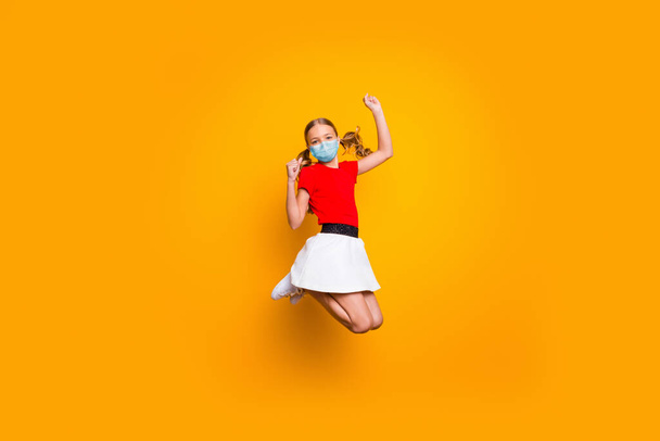 Full length body size view of her she pretty girl jumping wearing safety gauze mask disease recovery having fun healthy life stop mers cov contamination isolated bright yellow color background - Foto, afbeelding
