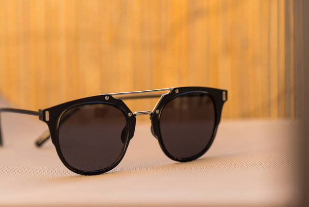Black sunglasses classic design in a sunny day of summer closeup. Selective Focus - Photo, Image