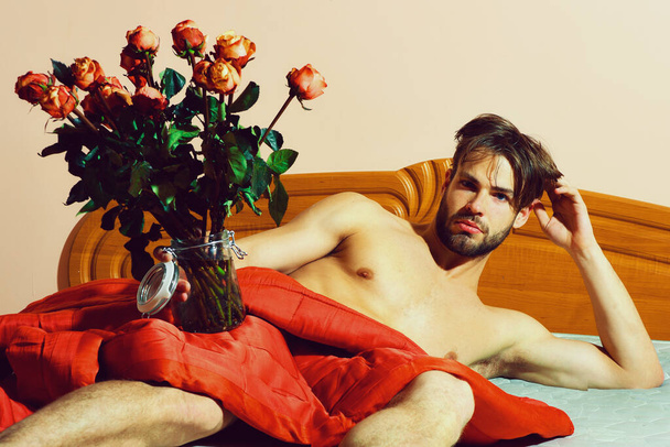 bearded macho man with roses - Φωτογραφία, εικόνα