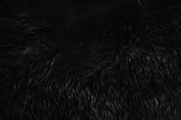 Schwarze Wolltextur Hintergrund, dunkle natürliche Schafwolle, schwarze nahtlose Baumwolle, Textur aus grauem, flauschigem Fell, Nahaufnahme Fragment aus schwarzem Wollteppich - Foto, Bild