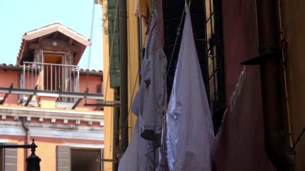 4K. Clothes hanging on the facade of a house on a narrow street in Venice, Italy. Clothes drying in the window. - Footage, Video