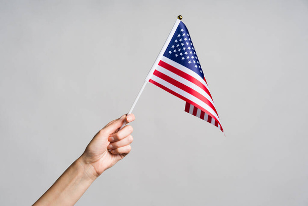 Human hand holding USA flag - Foto, afbeelding