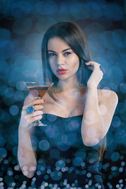 Sexy diva holding a cocktail glass - 写真・画像