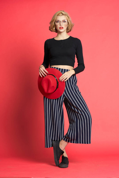 Pretty woman with red hat fashionable clothes pink isolated background glamor - Φωτογραφία, εικόνα