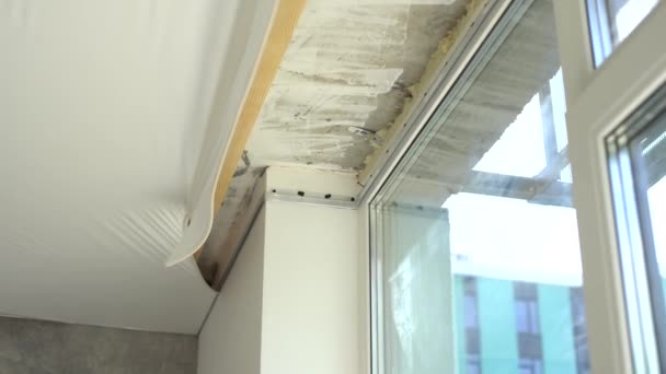 Process of dismantling of stretch suspended ceiling in flat, closeup view. Interior, indoors. - Footage, Video
