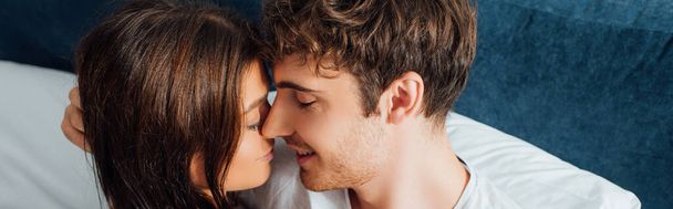 Panoramic crop of couple embracing each other with closed eyes - Photo, Image
