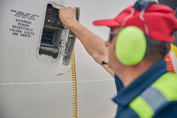 Tapasztalt mérnök ellenőrzi a légi jármű interphone rendszerét - Fotó, kép