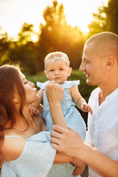 Happy young family with baby girl  in the park - Foto, immagini