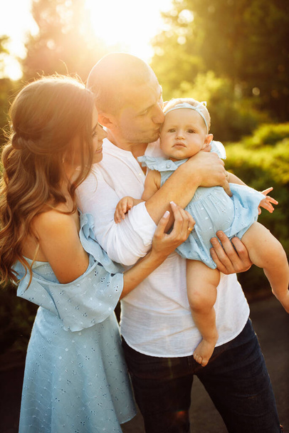 Happy young family with baby girl  in the park - Foto, Bild