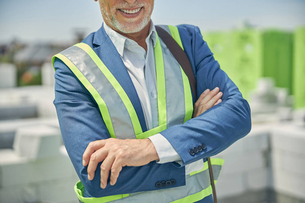 Modern civil engineer with his arms folded standing outside - Photo, Image