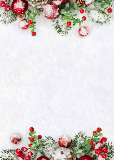 Christmas decoration. Frame of cones pine, twigs christmas tree, red balls, red berries on snow with space for text. Top view, flat lay. - Photo, image