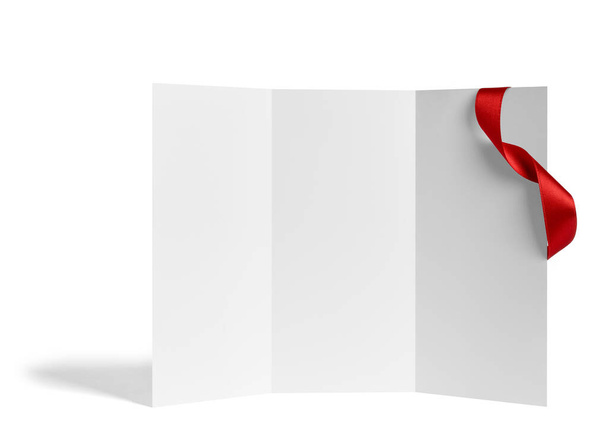 close up of a  blank folded leaflet or a desktop calendar with ribbon on white background  - Photo, Image