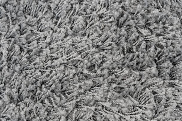 Black natural fleece carpet texture background. Dark wool fabric texture. fragment gray shaggy mat - Photo, Image