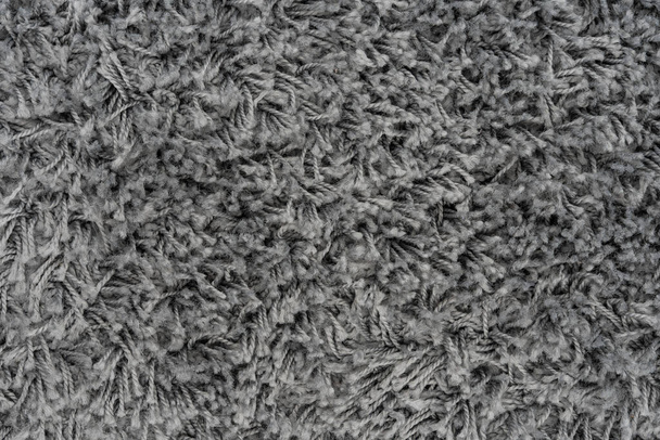 Black natural fleece carpet texture background. Dark wool fabric texture. fragment gray shaggy mat - Photo, Image