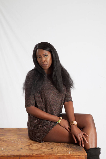 Pretty Black woman sitting thoughtfully - Valokuva, kuva