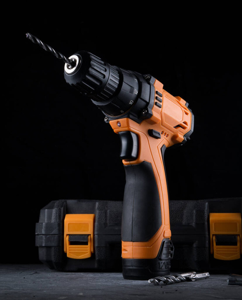 Cordless drill. Close up Electric drill, Screwdriver set on black background. Hammer drill or screwdriver, Electric cordless hand drill. maintenance home concept. - Photo, Image