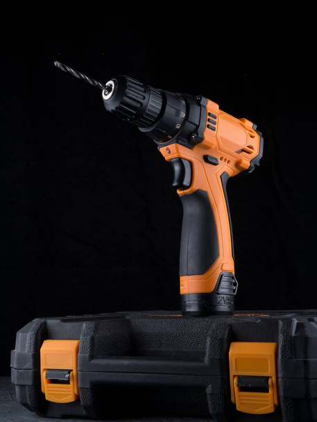 Cordless drill. Close up Electric drill, Screwdriver set on black background. Hammer drill or screwdriver, Electric cordless hand drill. maintenance home concept. - Photo, Image