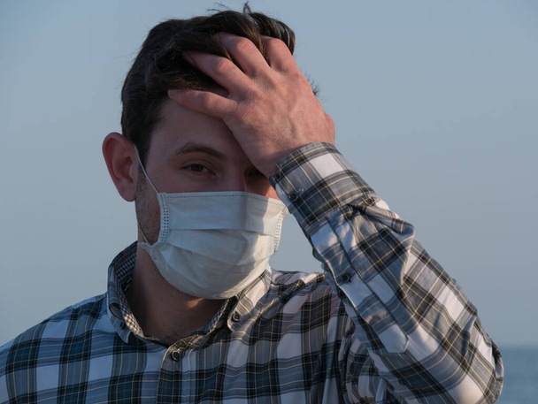 homem usando máscara facial durante o surto de coronavírus. Vírus propagação carantina prevenção da gripe. um homem com uma máscara facial. máscara descartável. Fica em segurança. Pare covid 19. bloqueio - Foto, Imagem