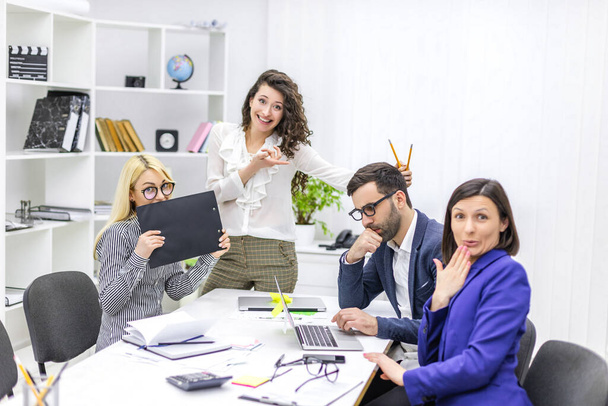 Photo of team working at desks in busy office. - Foto, Bild