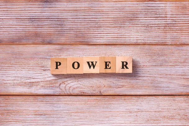 Power Word Written In Wooden Cube. Concept of power or powerful in business. - Photo, Image