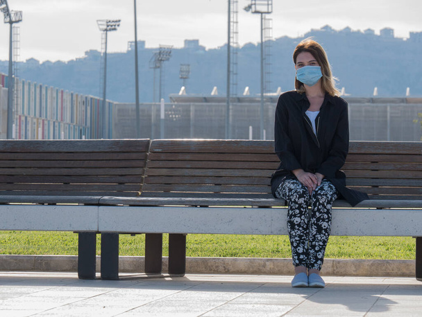 Woman wearing face mask during coronavirus outbreak. Virus spread flu prevention carantine. Girl in a facemask. disposable mask. stay safe . stop covid 19. lockdown - Photo, Image