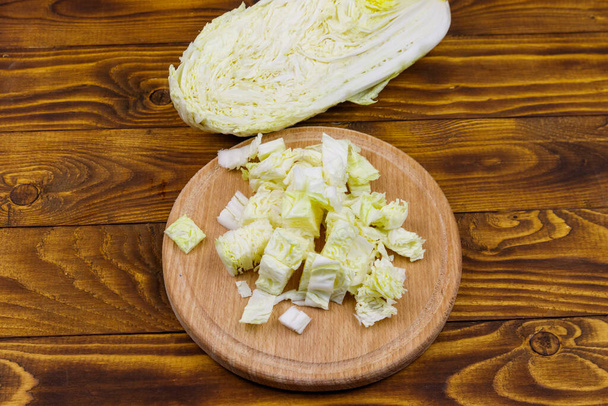 Chopped chinese cabbage on cutting board on wooden table - Foto, Imagem
