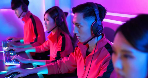 close up of pan asian cyber sport gamers team play game while clicking the mouse and keyboard - Foto, Bild