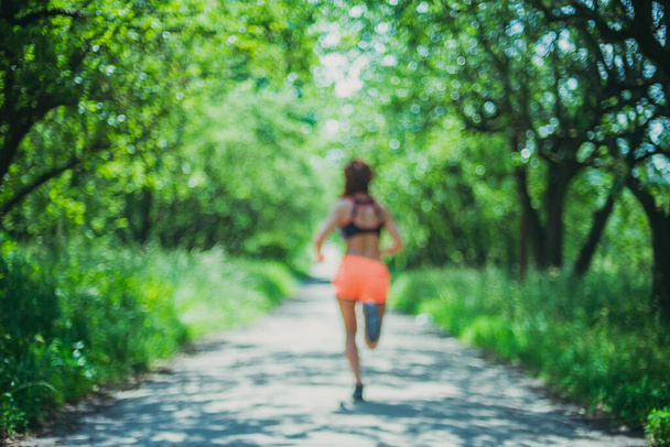 Run. A young woman runs in a public park. - Photo, Image