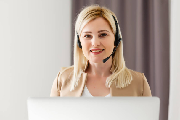 Cheerful woman wear headset laugh using laptop video stream conference call teach online, happy ethnic girl student gamer tutor have fun watch webinar web cam education entertainment concept - Photo, Image
