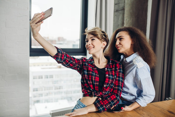 time for selfie. gorgeous stylish girls are looking at the camera of smartphone - Foto, Bild