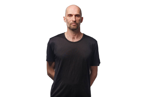 Image of bald serious adult man in black shirt - Photo, Image