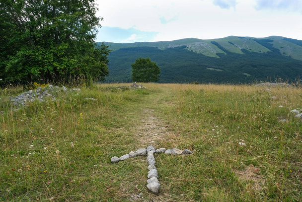 flèche en pierres indiquant la direction du sentier dans le col San Leonardo sur la zone de montagne de la maiella à abruzzo - Photo, image