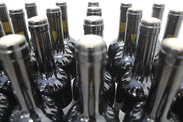 Glasflaschen in einer Weinfabrik gestapelt. - Foto, Bild