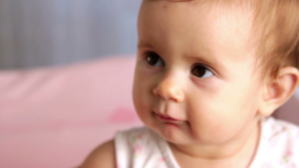 Little baby looking into camera (emotion),small child cheerfully plays - Footage, Video