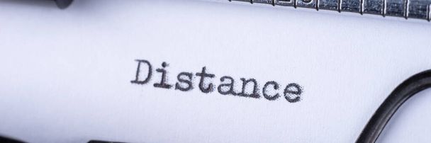 Distance on white sheet in vintage typewriter. Panoramic image - Photo, Image