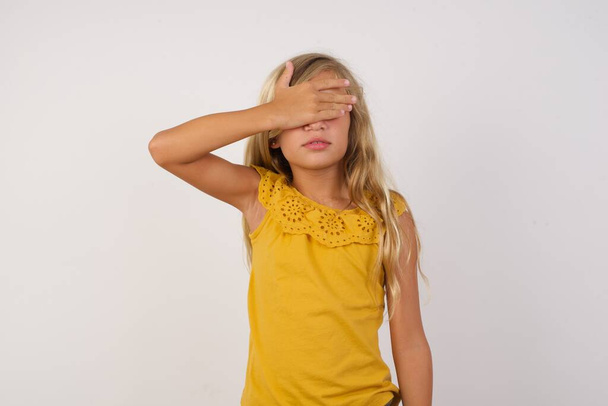 Girl  with hand on face covering eyes for surprise. Blind concept. - Photo, Image