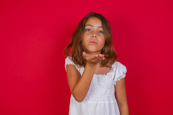 Cute little girl  blowing a kiss with hand. Love expression. - 写真・画像