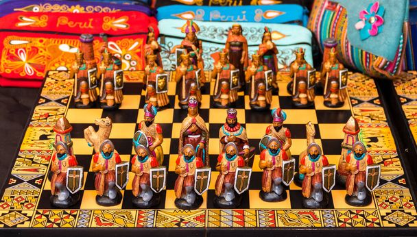 The traditional chess game art and craft product with Spanish against Inca people on a local handicraft market in Pisac, near Cusco, Peru - Photo, Image