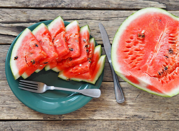 Sliced red watermelon on a wooden table. Food background. - Foto, immagini