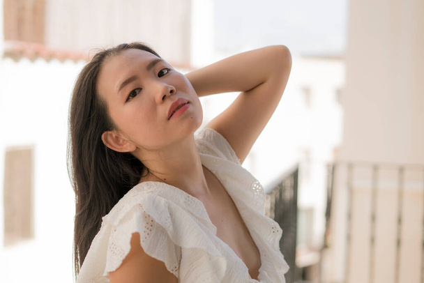 lifestyle portrait of young attractive and beautiful Asian Korean woman outdoors at urban balcony in Spain enjoying summer holidays travel happy and carefree - Foto, afbeelding
