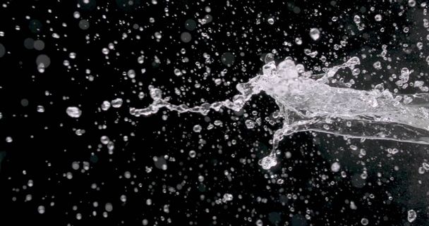macro shot of water spattering against a black background. - Photo, Image
