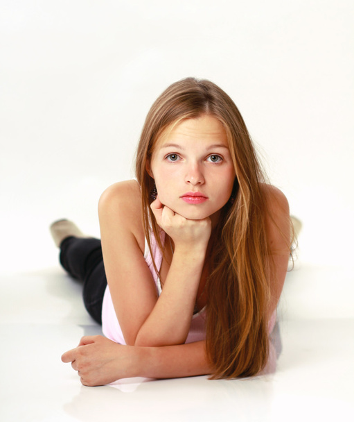 Portrait of young girl laying on floor - Fotoğraf, Görsel