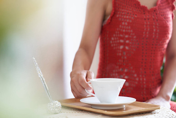 Μια γυναίκα χαλαρώνει με ένα φλιτζάνι τσάι σε ένα σαλόνι ομορφιάς - Φωτογραφία, εικόνα